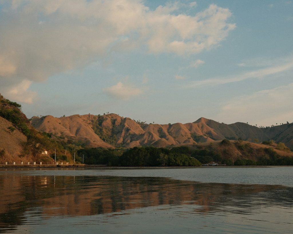 A body of water with mountains in the background